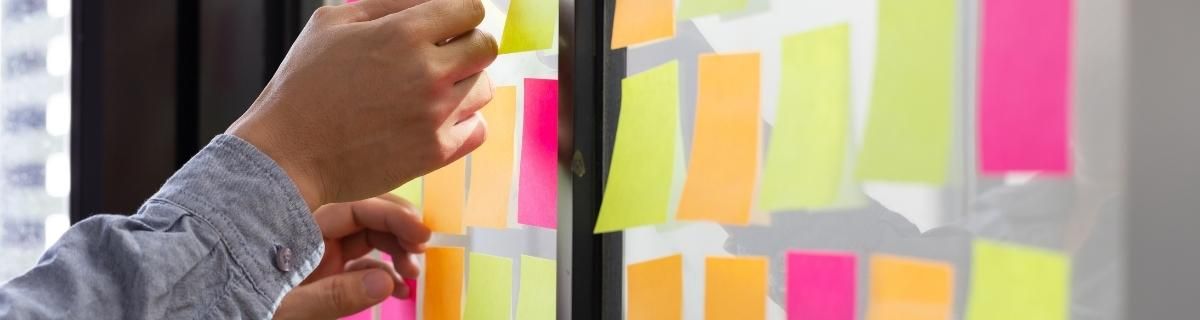 Hand placing sticky notes